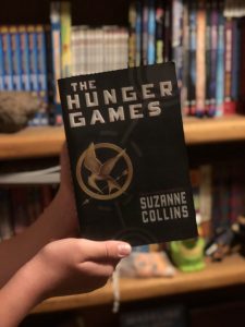 Cover of the Hunger Games showing a mockingjay symbol