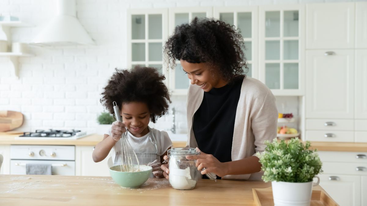 Mom and daughter homeschool by baking together